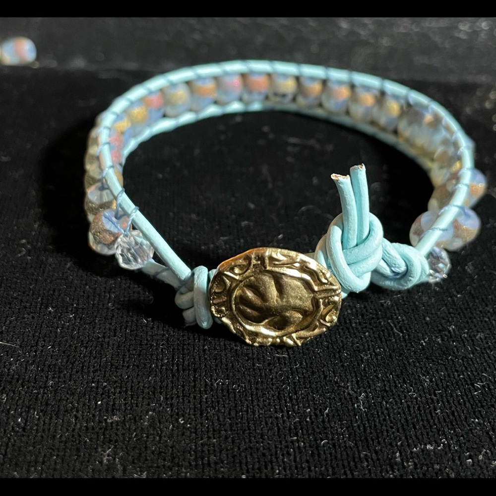 Single wrap bracelet, leather cord, a brass button and beautiful glass beads.